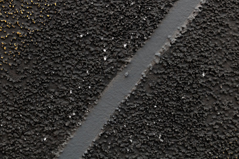 Detailní pohled na abstraktní obraz se zlatými tečkami na černém pozadí, zvýrazňující texturu a kompozici s diagonální linií Papilora.