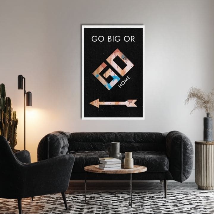 Obraz s nápisem „GO BIG OR GO HOME“ a šipkou visí v moderním interiéru nad dřevěnou konzolí s vázou a svíčkou Papilora.