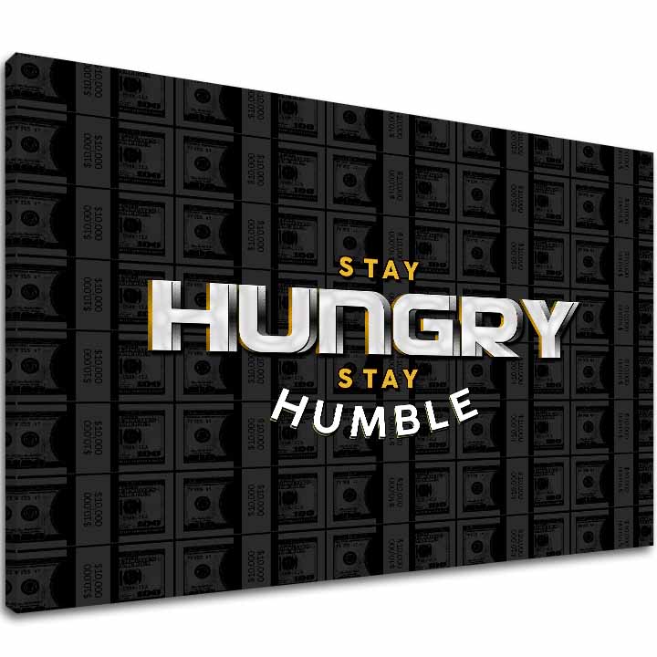 Na plátně je zobrazen motivační citát „STAY HUNGRY STAY HUMBLE“ na pozadí stohů bankovek v šedých tónech, s viditelným dřevěným rámem Papilora.