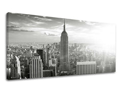 Černobílý tisk na plátně zachycuje ikonické panorama New Yorku s dominantní budovou Empire State Building, s viditelným dřevěným rámem Papilora.